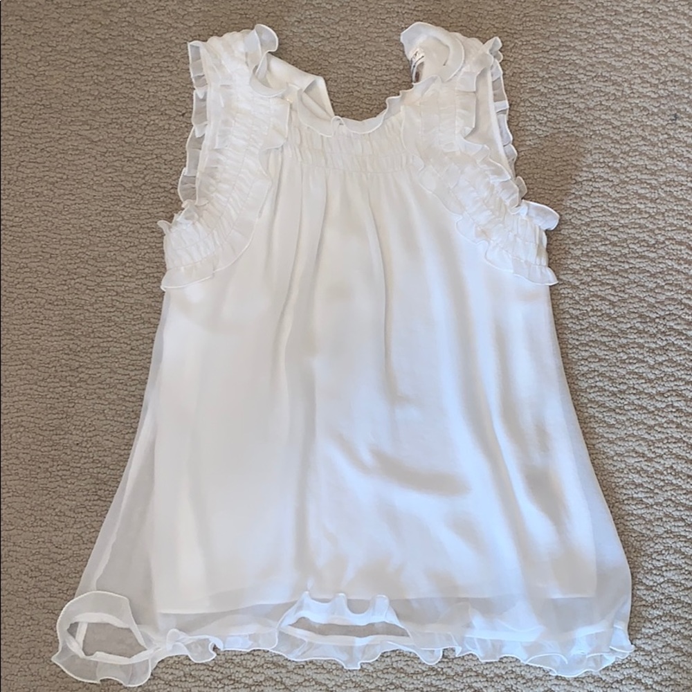 White ruffle sleeveless shirt